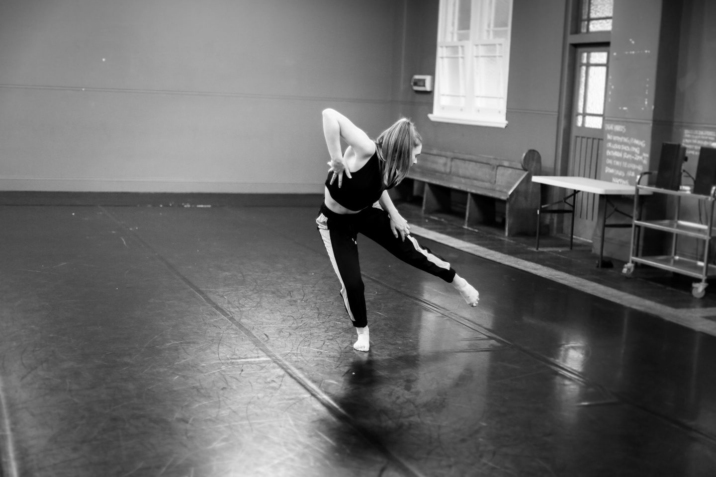 Dancer stage left with left leg lifted