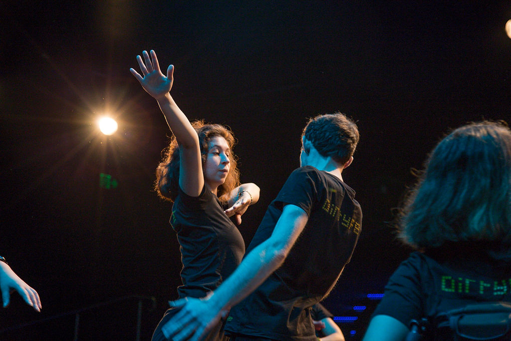 two dancers arms reaching up 